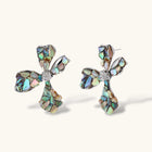 Pair of oversized four-petal flower stud earrings with iridescent teal and blush shell mosaic on silver-tone petals.