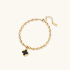 18K gold-plated oval bead bracelet with a four-leaf clover charm in mother-of-pearl or black enamel, adjustable lobster clasp, on white background.