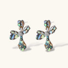 Pair of oversized four-petal flower stud earrings with iridescent teal and blush shell mosaic on silver-tone petals.